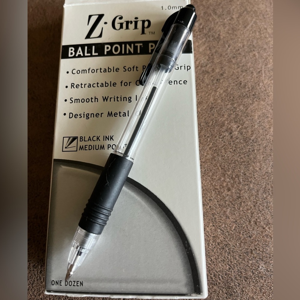Package of 12 retractable black ballpoint pens. Soft rubber grip. Smooth writing